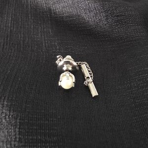 Vintage silver tone pearl tie tack with a chain.